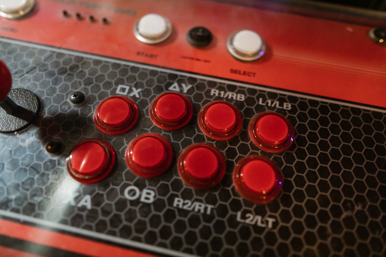 Detailed view of a retro arcade machine control panel with colorful buttons and joystick.